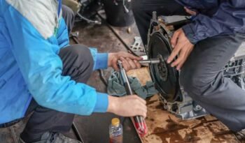 2 mechanic men try to fix and setup boat engine.